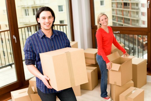 Efficient office move day in Aldgate with labeled boxes and business equipment